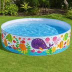 Children's inflatable pool with colorful underwater animal design on grass