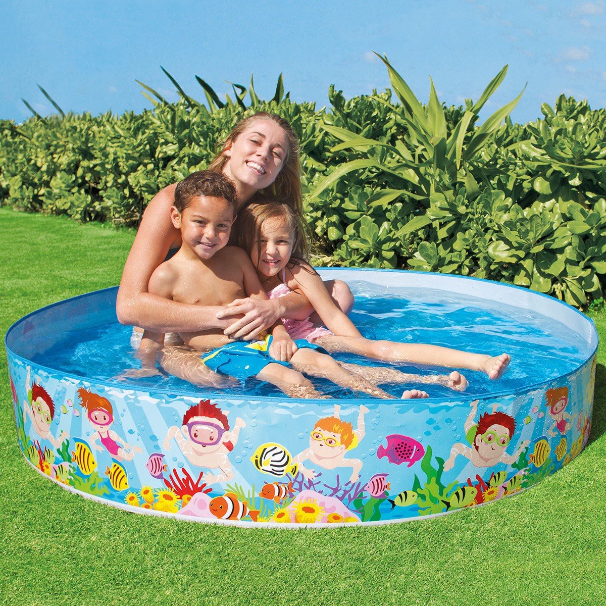 Children playing in a inflatable pool with cartoon characters on a grassy area.